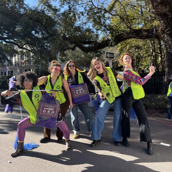 A group of RecycleDat! volunteers posing with grabbers and bead bags